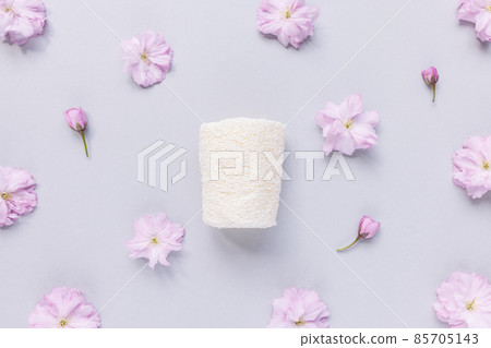 Loofah sponge. Natural bath, shower, body or face sponge. Pink floral background 85705143