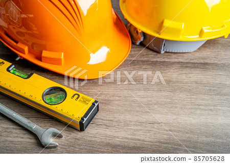 Safety first hard helmet hat and engineer tool with copy space, engineering construction and architecture concept. Safety first hard helmet hat and engineer tool with copy space, engineering construction and architecture concept. 85705628
