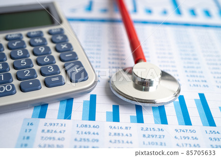 Stethoscope and calculator on charts and graphs paper, Finance, Account, Statistics, Investment, Analytic research data economy and Business company concept. 85705633