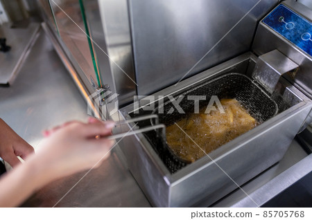 Close up picture of hands stirring rice 85705768