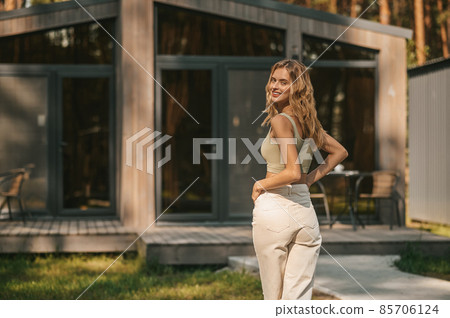 Pretty young blonde woman spending time outside and feeling relaxed 85706124