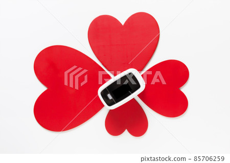 Covid Valentine day gift concept, pulse oximeter among flower from red hearts on white top view 85706259