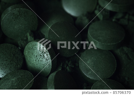 Spirulina powder and tablets algae. Macro close up. Spirulina powder and tablets algae. Macro close up. 85706370