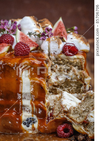 Caramel cake with wild berries, cream and figs on brown background 85706706