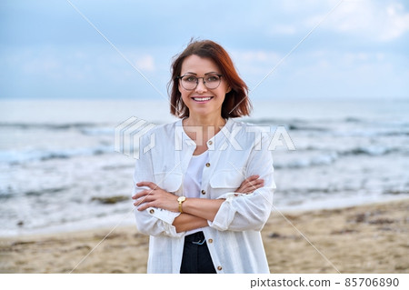 Outdoor portrait of successful middle aged woman with folded hands. Outdoor portrait of successful middle aged woman with folded hands. 85706890