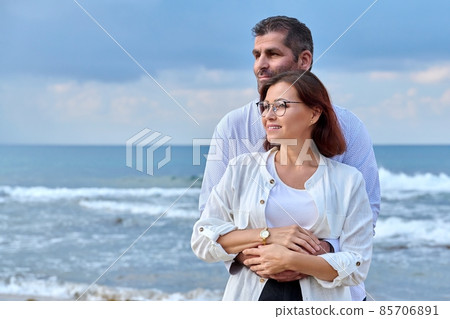 Outdoor portrait of mature couple hugging on the seashore, copy space Outdoor portrait of mature couple hugging on the seashore, copy space 85706891