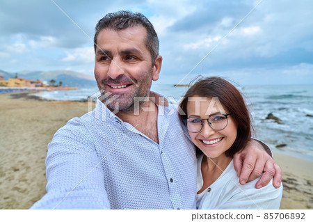 Happy mature couple taking selfie photo on smartphone. Happy mature couple taking selfie photo on smartphone. 85706892