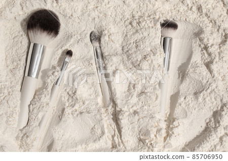 makeup brushes on white powder background 85706950