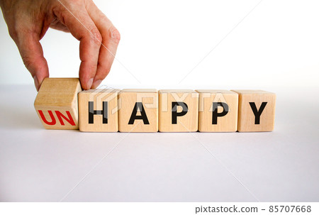 Be happy, do not unhappy symbol. Businessman turns the wooden cube and changes the word 'unhappy' to 'happy'. Beautiful white background. Business, happy or unhappy concept. Copy space. 85707668
