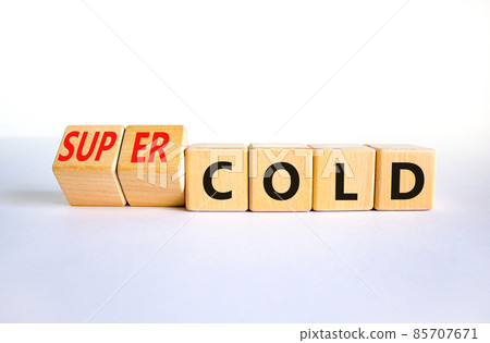 Super cold symbol. Turned wooden cubes and changed concept words cold to super cold. Beautiful white table, white background, copy space. Medical and super cold concept. 85707671