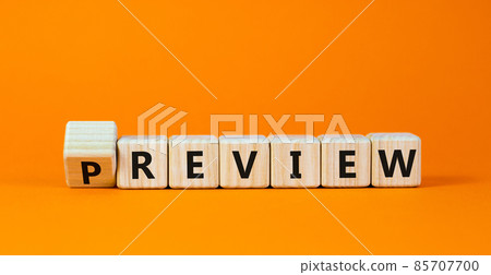 Preview or review symbol. Turned the cube and changed the word 'preview' to 'review'. Beautiful orange background, copy space. Business, preview or review concept. 85707700