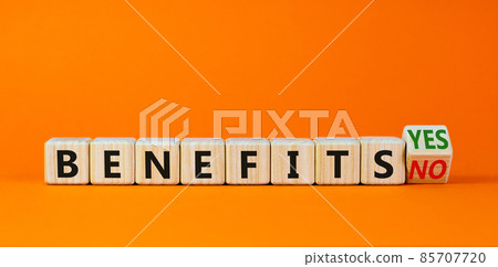 Benefits symbol. Turned a wooden cube and changed words 'benefits no' to 'benefits yes'. Beautiful orange background. Business and benefits concept, copy space. Benefits symbol. Turned a wooden cube and changed words 'benefits no' to 'benefits yes'. Beautiful orange background. Business and benefits concept, copy space. 85707720