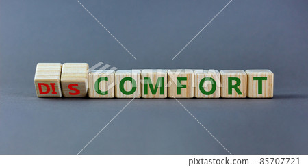 From discomfort to comfort symbol. Turned a cube and changed the word 'discomfort' to 'comfort'. Beautiful grey background, copy space. Business and from discomfort to comfort concept. 85707721