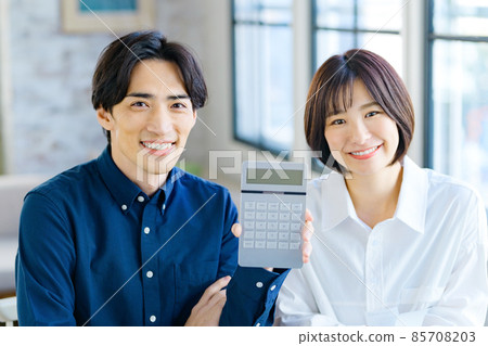 Image of a young couple's final tax return calculated while looking at the receipt at home Image of a young couple's final tax return calculated while looking at the receipt at home 85708203