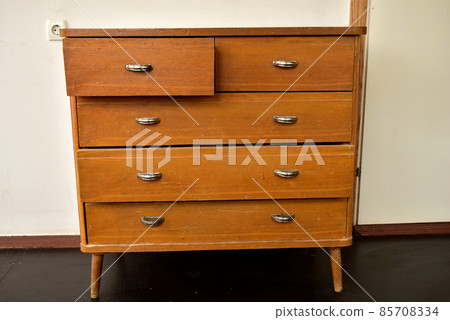 Old bedside table with drawers and handles. Old bedside table with drawers and handles. 85708334
