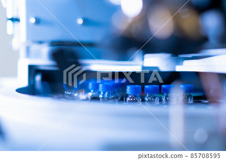 HPLC glass vials with blue caps in the auto sampler. Chemical analysis of plants and human samples 85708595
