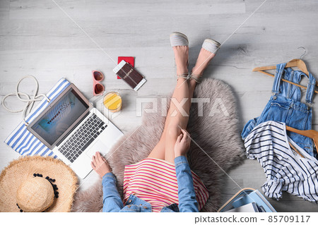 Travel blogger with laptop sitting on floor, top view 85709117