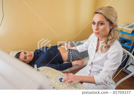 beautiful gynecologist examines the medical devices. The patient lies on the couch 85709337