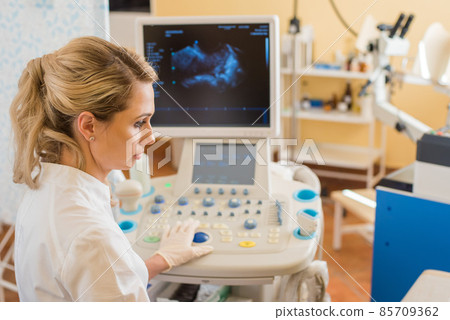 beautiful gynecologist examines the medical devices. The patient lies on the couch beautiful gynecologist examines the medical devices. The patient lies on the couch 85709362