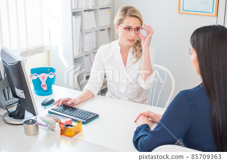 beautiful gynecologist communicates with the patient in the medical office beautiful gynecologist communicates with the patient in the medical office 85709363
