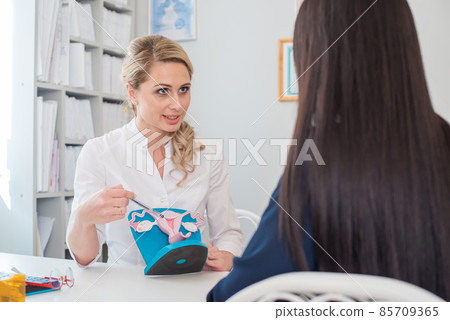 beautiful gynecologist communicates with the patient in the medical office beautiful gynecologist communicates with the patient in the medical office 85709365