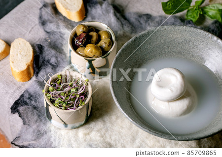Traditional italian burrata knotted cheese in bowl 85709865