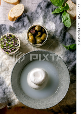 Traditional italian burrata knotted cheese in bowl Traditional italian burrata knotted cheese in bowl 85709867