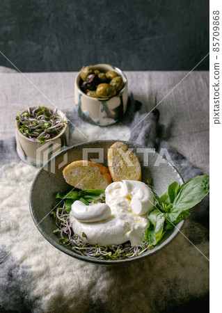 Traditional italian burrata knotted cheese in bowl 85709868