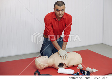 Arabian man learns to do artificial respiration on a mannequin. Arabian man learns to do artificial respiration on a mannequin. 85710140