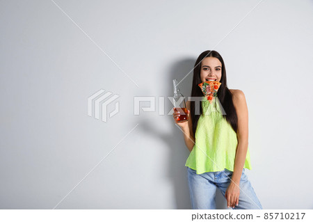 Happy woman with pizza and beer on white background, space for text Happy woman with pizza and beer on white background, space for text 85710217