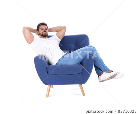 Young man resting in armchair isolated on white 85710325