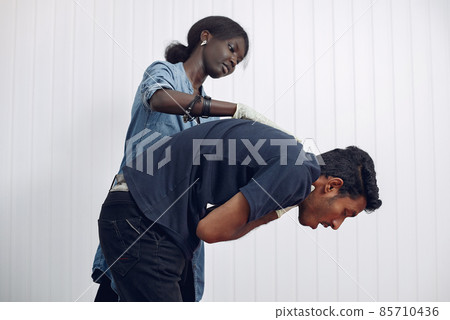 African woman provides medical care to men. African woman provides medical care to men. 85710436
