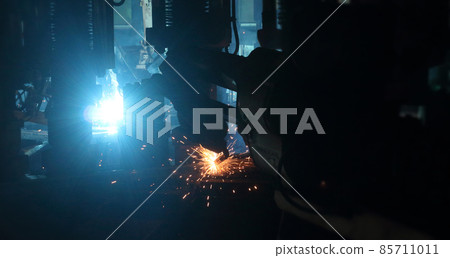 welding robot in the automotive parts industry, The movement of the robot welding in auto parts factory. welding robot in the automotive parts industry, The movement of the robot welding in auto parts factory. 85711011
