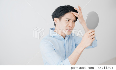 Young man doing a hair check 85711893