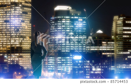 Woman looking at night city Woman looking at night city 85714453