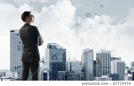 Concept of business success and control with confident boss against cityscape background Concept of business success and control with confident boss against cityscape background 85714454