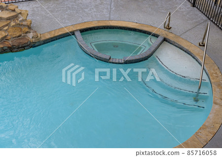 Backyard swimming pool opening with water before cleaning Backyard swimming pool opening with water before cleaning 85716058