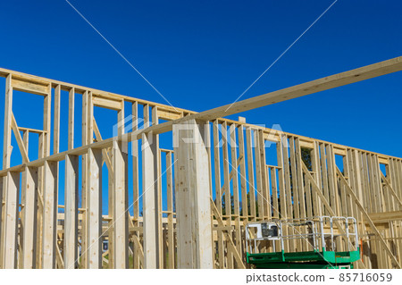 Fragment of a new home under construction wood framing beams Fragment of a new home under construction wood framing beams 85716059