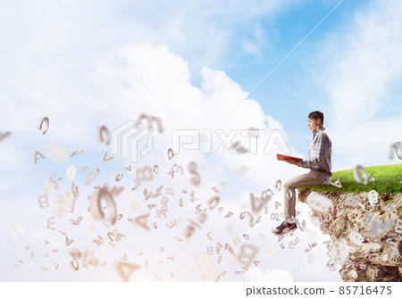 Student guy in suit with book in hands preparing for exam 85716475