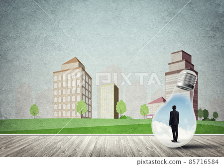 Businessman trapped in bulb Businessman trapped in bulb 85716584