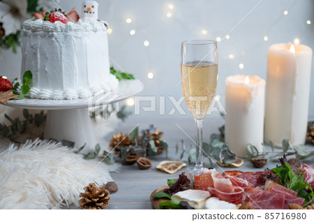 Christmas dinner with shining candles and illuminations | Assorted prosciutto, chanmery and strawberry cake 85716980