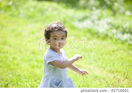 Girls playing in the field Girls playing in the field 85718081