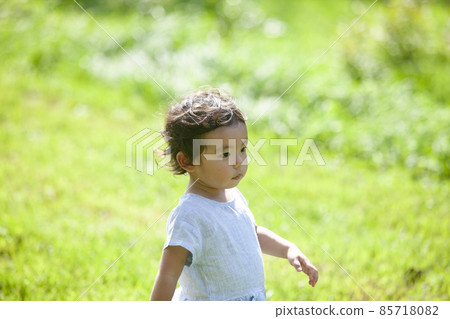Girls playing in the field Girls playing in the field 85718082