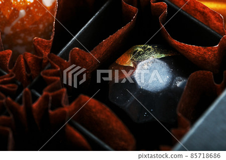 Exquisite handmade chocolate candy is painted with patterns of galaxy stars close-up 85718686