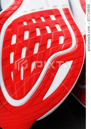 Close-up of the sole of a sport running shoe for running in red 85718698