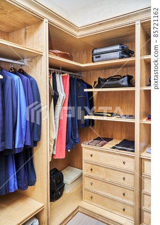 Stylish walk in closet with furniture made of maple wood Stylish walk in closet with furniture made of maple wood 85721162