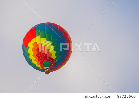 Colorful hot air balloon flying against grey sky at Winter aerostat festival Colorful hot air balloon flying against grey sky at Winter aerostat festival 85722666