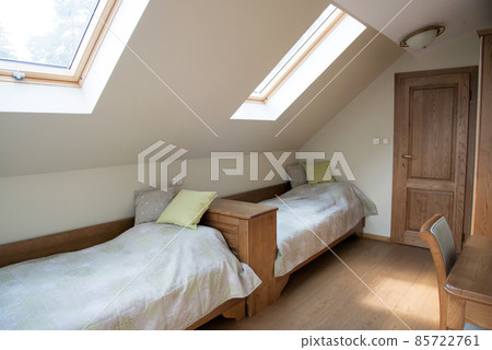 bedroom interior in light pastel tones and sloping roof 85722761