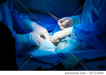 Surgical instruments in the hands of doctors during a surgical operation. Surgical instruments in the hands of doctors during a surgical operation. 85722848
