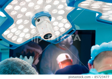 Medical lighting above the operating table during surgery. Medical lighting above the operating table during surgery. 85723477